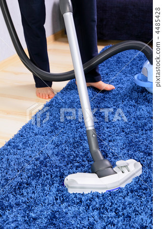 Vacuum cleaner in action-men cleaner a carpet. Vacuum cleaner in action-men cleaner a carpet. 4485428