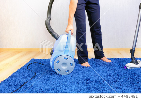 Vacuum cleaner in action-men cleaner a carpet. Vacuum cleaner in action-men cleaner a carpet. 4485481