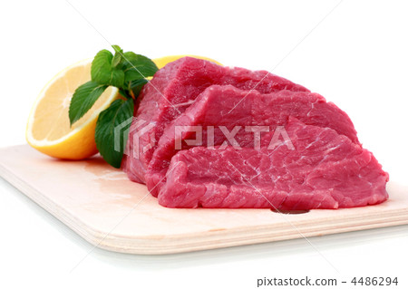 Beef steak  on meat hardboard with green leaf and lemon. 4486294