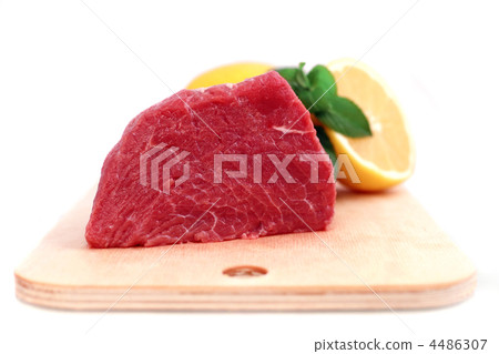 Beef steak  on meat hardboard with green leaf and lemon. 4486307