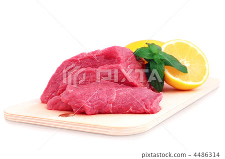 Beef steak  on meat hardboard with green leaf and lemon. 4486314