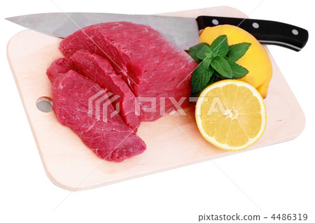 Cut of  beef steak ,  knife with lemon slice. 4486319