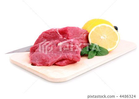 Cut of  beef steak ,  knife with lemon slice. 4486324