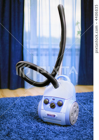Vacuum cleaner stand on blue carpet. Vacuum cleaner stand on blue carpet. 4486835