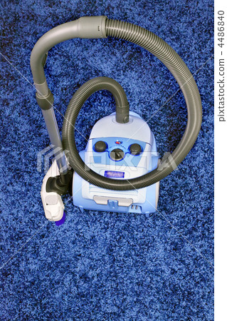 Vacuum cleaner stand on blue carpet. Vacuum cleaner stand on blue carpet. 4486840