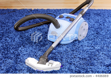 Vacuum cleaner stand on blue carpet. Vacuum cleaner stand on blue carpet. 4486869