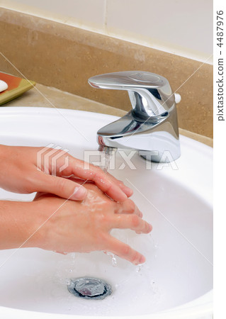 Washing hands in sink. 4487976