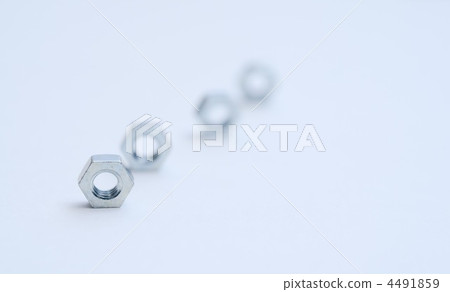 Hexagonal nuts lined up against a white background Hexagonal nuts lined up against a white background 4491859