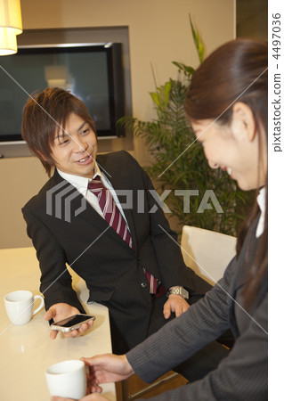 Male and female businessmen talking with a smile while taking a break 4497036