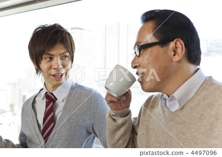 Two businessmen talking while drinking coffee Two businessmen talking while drinking coffee 4497096