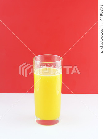 Glass of fresh orange juic? on  red background. 4499873