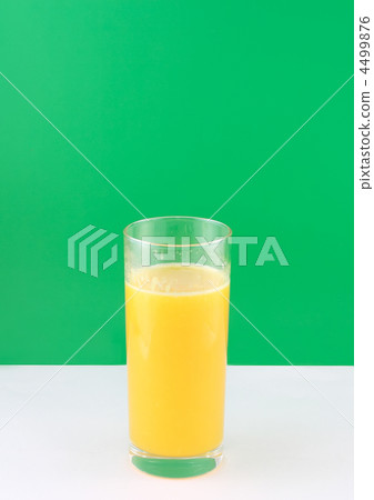 Glass of fresh orange juic? on green background. Glass of fresh orange juic? on green background. 4499876