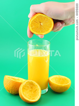 Orange juice with hand, squeeze of orange. 4499880
