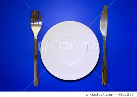 Table serving-dishware on colour backdrop. 4501855