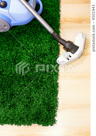 Vacuum cleaner on green carpet Vacuum cleaner on green carpet 4501941