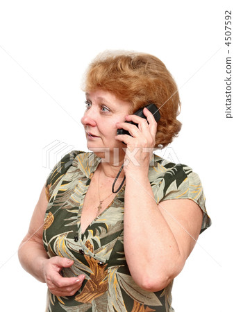 Senior lady speaks by a mobile phone. Senior lady speaks by a mobile phone. 4507592