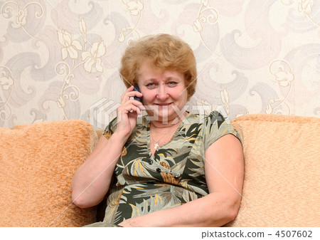 Senior lady speaks by a mobile phone. 4507602