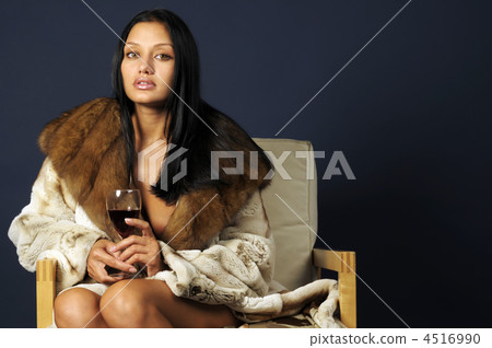 woman in furs with wine. 4516990