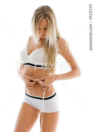 Beautiful blonde is measuring her waist 4522143