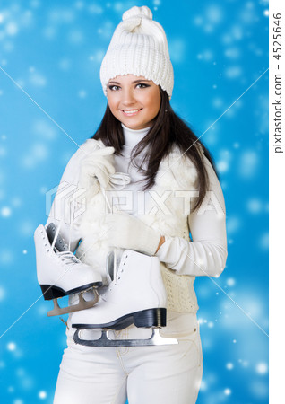 Beautiful woman in winter clothes with skates. 4525646