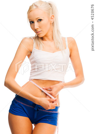 beautiful blonde is measuring her waist beautiful blonde is measuring her waist 4528676