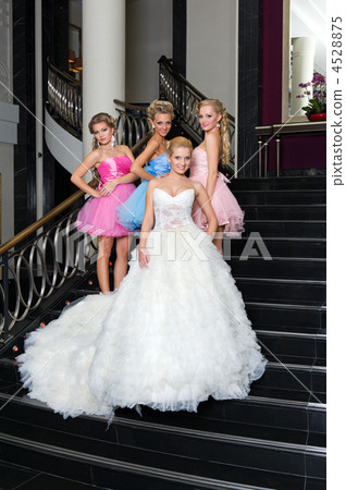 The bride with her bridesmaids on the stairs The bride with her bridesmaids on the stairs 4528875