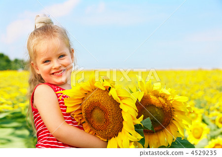 Kid holding sunflower outdoor. Kid holding sunflower outdoor. 4529235