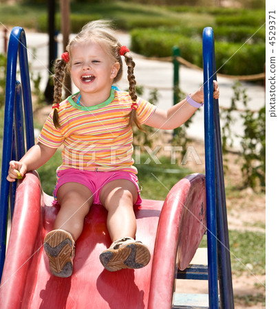 Child on slide in playground.Outdoor park. Child on slide in playground.Outdoor park. 4529371