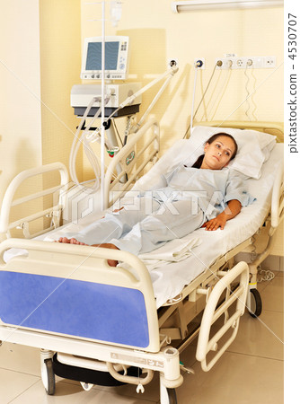 Woman on gurney in operating room. 4530707