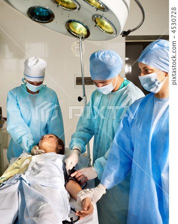 Woman on gurney in operating room. 4530728