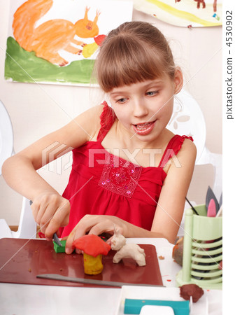 Child playing with plasticine in school. 4530902