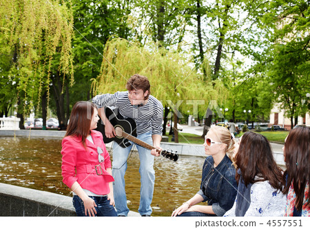 Group of people in city park listen music. Group of people in city park listen music. 4557551