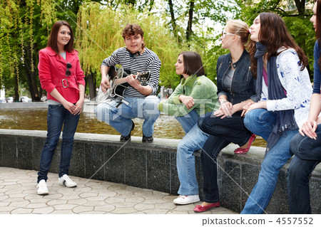 Group of people in city park listen music. Group of people in city park listen music. 4557552