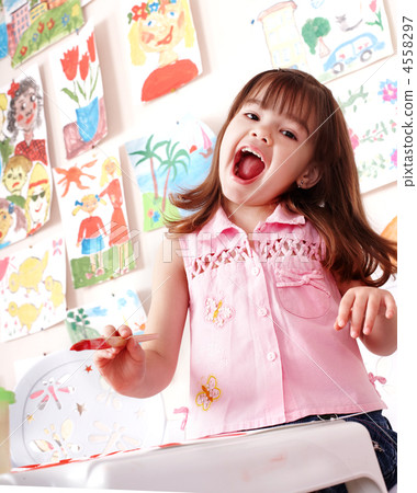 Child with picture and brush in play room. Child with picture and brush in play room. 4558297
