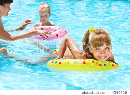 Happy family with children sitting on inflatable ring. 4559526