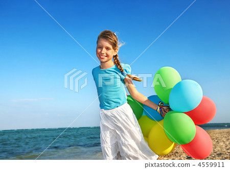 Child playing with balloons at the beach Child playing with balloons at the beach 4559911