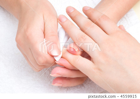 manicure applying - wiping the mosturizer from cuticles 4559915