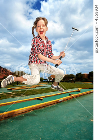 little girl playing golf in park. 4559934