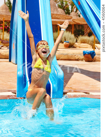 Child on water slide at aquapark. Child on water slide at aquapark. 4560064