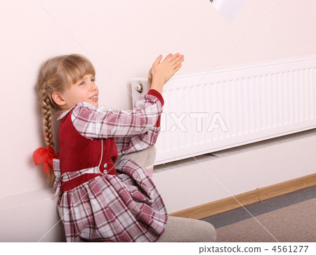 Girl warm one's hands near radiator. Crisis. Girl warm one's hands near radiator. Crisis. 4561277