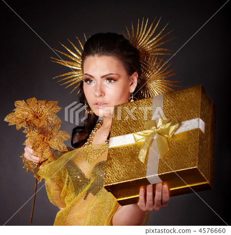 Young woman with gold feather on grey background. Young woman with gold feather on grey background. 4576660