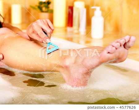 Woman shaving her legs 4577626