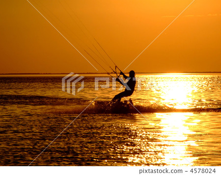 Silhouette of a kitesurf on a gulf on a sunset 2 Silhouette of a kitesurf on a gulf on a sunset 2 4578024
