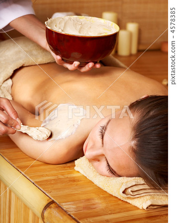 Young woman  having clay body mask. 4578385