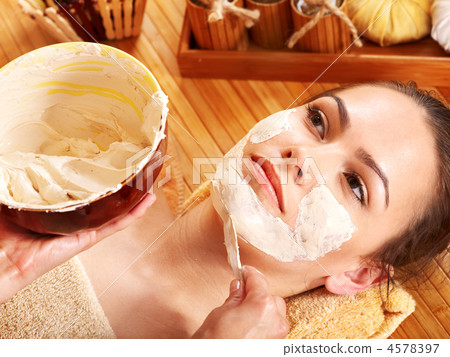 Young woman  having clay facial mask. 4578397