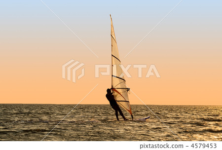 Silhouette of a windsurfer on waves of a gulf Silhouette of a windsurfer on waves of a gulf 4579453