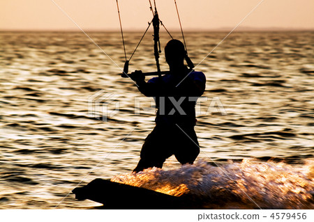 Silhouette of a kitesurfer on a gulf 4579456