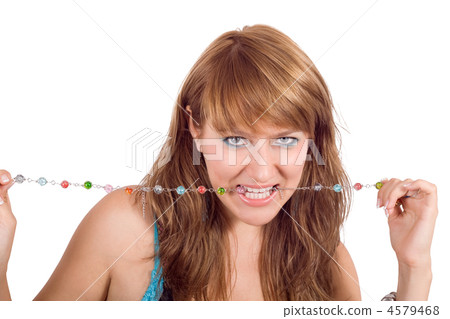 Portrait of the young beautiful woman with a beads in a teeth Portrait of the young beautiful woman with a beads in a teeth 4579468