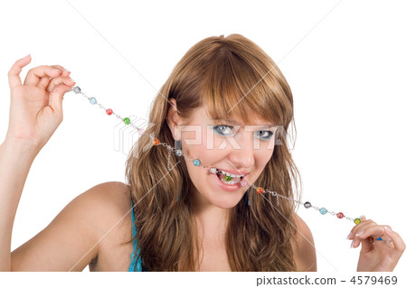Portrait of the young beautiful woman with a beads in a teeth. I 4579469