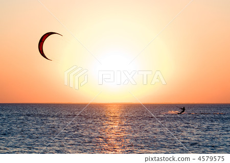 Kitesurfer on a gulf on a sunset 4579575